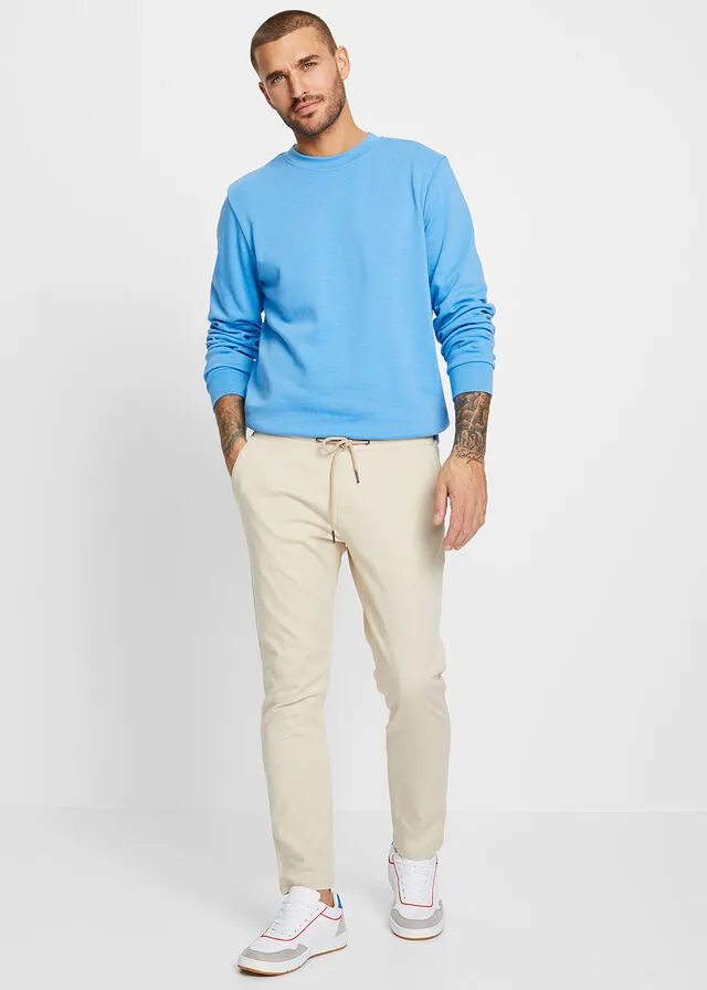 Pantalón chino elástico de corte regular, largo acortado y estilo tapered Arena claro